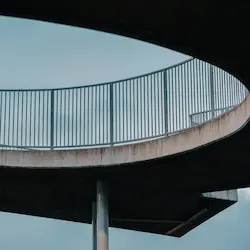 A circular concrete walkway showcasing retro architectural design in urban Glasgow.