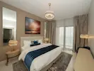 A luxurious contemporary bedroom featuring soft lighting that creates a warm and inviting atmosphere.