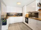 A spacious, well-equipped kitchen with modern appliances and a clean, inviting design.
