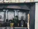 A traditional black stove adorned with ornamental metallic pots, creating a warm and inviting atmosphere.