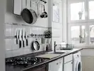A stunning white kitchen featuring grey and black accents, creating a sleek and modern aesthetic.