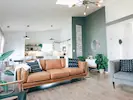 A spacious and inviting living room filled with natural light, creating a warm and comfortable atmosphere.