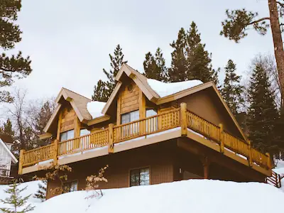 Hilltop, a timber-clad cabin nestled in the Southern Uplands, surrounded by snow-covered scenery.