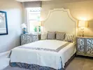 A cosy, well-lit bedroom featuring ornate decor, creating a warm and inviting atmosphere.