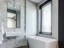 Bright and modern bathroom at Lily Pad Lodge featuring sleek fixtures and a minimalist design.