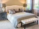 An immaculate and luxurious bedroom featuring elegant decor and high-end finishes.