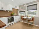 A clean and comfortable kitchen showcasing minimalist design features, creating a sleek and inviting space.