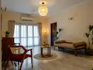 A spacious and sleek living room filled with abundant natural light, creating an open and airy atmosphere.