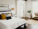 A lovely traditional bedroom filled with natural light, creating a warm and inviting atmosphere.