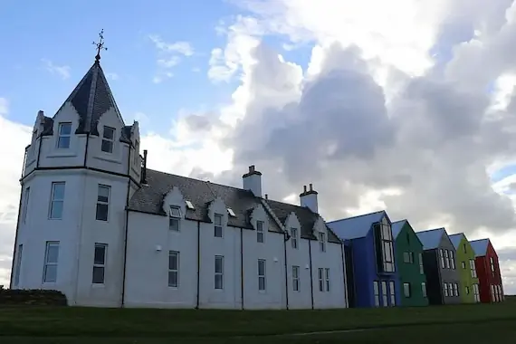 A picturesque row of white and colourful buildings in John O' Groats, the iconic northernmost village in mainland Scotland.